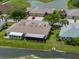 Aerial view of home showing pond, expansive backyard, sunroom, and extended patio at 10324 Chatuge Dr, San Antonio, FL 33576
