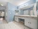 Bright bathroom featuring double sinks, tiled floors, and ample natural light at 10324 Chatuge Dr, San Antonio, FL 33576