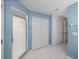 Bathroom with tiled floor, glass shower enclosure, and bi-fold doors at 10324 Chatuge Dr, San Antonio, FL 33576