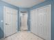 Bathroom featuring white tiled floor, glass enclosed shower, and blue painted walls at 10324 Chatuge Dr, San Antonio, FL 33576