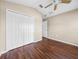 Bedroom with hardwood floors, closet and ceiling fan at 10324 Chatuge Dr, San Antonio, FL 33576