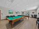 This recreation room offers two billiard tables surrounded by comfortable seating and a light-filled ambiance at 10324 Chatuge Dr, San Antonio, FL 33576