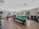 Inside the billiard room featuring two pool tables, chairs, and bar tables in Tampa Bay Golf and Country Club at 10324 Chatuge Dr, San Antonio, FL 33576