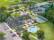 Aerial view of the community clubhouse with shuffleboard, pool, and ample parking at 10324 Chatuge Dr, San Antonio, FL 33576