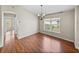 Dining room featuring hardwood floors, a chandelier, and a bright window at 10324 Chatuge Dr, San Antonio, FL 33576