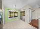 Bright dining room with tiled floor, sliding glass doors, and light green accent wall at 10324 Chatuge Dr, San Antonio, FL 33576