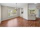Dining room with hardwood floors, bright window, and open access to kitchen at 10324 Chatuge Dr, San Antonio, FL 33576