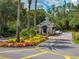 Community entrance with manicured landscaping and guard house at 10324 Chatuge Dr, San Antonio, FL 33576