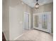 The foyer showcases tile floors, a stylish light fixture, and an entry door, creating a welcoming atmosphere at 10324 Chatuge Dr, San Antonio, FL 33576