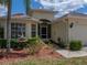 This home has mature landscaping, an attached two-car garage, stone detailing, and an elegant and inviting entrance at 10324 Chatuge Dr, San Antonio, FL 33576