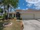 A charming one-story home boasting an attached two-car garage, lush landscaping, and a well-maintained front yard at 10324 Chatuge Dr, San Antonio, FL 33576