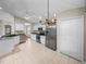 Well-equipped kitchen with stainless steel appliances, granite countertops, and eat-in dining area at 10324 Chatuge Dr, San Antonio, FL 33576