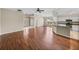Spacious living room features hardwood floors, ceiling fan, and an arched entry for a modern feel at 10324 Chatuge Dr, San Antonio, FL 33576