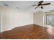 Open living room with hardwood floors, ceiling fan, and bright, welcoming entryway at 10324 Chatuge Dr, San Antonio, FL 33576