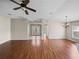 Bright living room showcases hardwood floors, modern ceiling fan, and arched entryways at 10324 Chatuge Dr, San Antonio, FL 33576