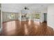 A spacious living room with hardwood floors and views of the backyard, flowing into the kitchen and dining areas at 10324 Chatuge Dr, San Antonio, FL 33576