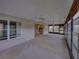 Covered outdoor patio showing access to home interior, sunroom, and outdoor views at 10324 Chatuge Dr, San Antonio, FL 33576
