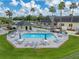 Aerial view of the community pool and clubhouse with seating and umbrellas at 10324 Chatuge Dr, San Antonio, FL 33576