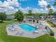 Aerial view of community pool area with seating and umbrellas at 10324 Chatuge Dr, San Antonio, FL 33576