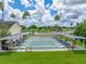 Tampa Bay Golf and Country Club's shuffleboard courts are surrounded by palms, benches, and lush green grass at 10324 Chatuge Dr, San Antonio, FL 33576