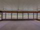 Sunroom featuring a wall of windows offering a view of the water and golf course at 10324 Chatuge Dr, San Antonio, FL 33576