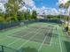 This is an overhead view of a pristine, fenced-in tennis court in Tampa Bay Golf and Country Club at 10324 Chatuge Dr, San Antonio, FL 33576