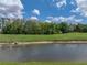 Water view of lush golf course with pond at 10324 Chatuge Dr, San Antonio, FL 33576