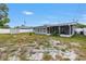 Backyard with the back of the house, fence, shed and partially enclosed patios at 11315 86Th Ave, Seminole, FL 33772