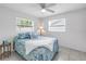 Bright bedroom with two windows, tile flooring and a comfy bed with a patterned comforter at 11315 86Th Ave, Seminole, FL 33772