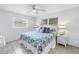 Bright bedroom with a ceiling fan, white wicker furniture, and two windows for ample natural light at 11315 86Th Ave, Seminole, FL 33772
