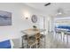 Cozy dining area with seating for four, featuring a wall-mounted clock and adjacent to a living area at 11315 86Th Ave, Seminole, FL 33772