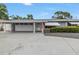 Beautiful single-story home with a spacious driveway and a welcoming entrance with an American flag at 11315 86Th Ave, Seminole, FL 33772