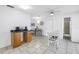 Bright eat-in kitchen with modern lighting, a breakfast table, and white tile flooring throughout at 11315 86Th Ave, Seminole, FL 33772