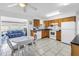 Well-lit kitchen with oak cabinets, white appliances, and an adjacent breakfast nook offering a cozy dining space at 11315 86Th Ave, Seminole, FL 33772