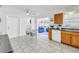Bright kitchen with white cabinetry, appliances, and tile flooring with views to the dining and living area at 11315 86Th Ave, Seminole, FL 33772