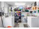 Functional laundry room with washer, dryer, shelving, and other storage solutions at 11315 86Th Ave, Seminole, FL 33772