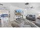 Bright and airy living room featuring neutral tones, modern furnishings, and seamless flow to the dining area at 11315 86Th Ave, Seminole, FL 33772