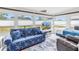 Bright sunroom featuring large windows, a couch with starfish pattern, and tile flooring at 11315 86Th Ave, Seminole, FL 33772