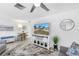 Stylish living room with a ceiling fan, tile flooring, and a media center, offering a comfortable gathering space at 11315 86Th Ave, Seminole, FL 33772