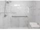 Modern shower with a built-in bench, grab bars, and white marble tiling throughout the space at 11315 86Th Ave, Seminole, FL 33772