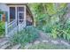 Screened-in porch and a stone path highlight the side of this home at 11386 Churchhill Trl, Seminole, FL 33772
