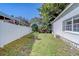 This backyard features a white fence surrounding a grass area and an adjacent enclosure at 11386 Churchhill Trl, Seminole, FL 33772