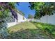 The backyard has a grass area, white fence, and plants at 11386 Churchhill Trl, Seminole, FL 33772