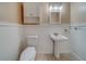 Half bathroom with decorative vanity and modern lighting at 11386 Churchhill Trl, Seminole, FL 33772