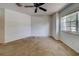 This bedroom features plush carpeting, a ceiling fan, and a sun-filled window at 11386 Churchhill Trl, Seminole, FL 33772