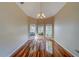 Bright dining room features hardwood floors, chandelier, and bay windows providing natural light at 11386 Churchhill Trl, Seminole, FL 33772