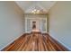 Dining room with hardwood floors connects to kitchen through white French doors at 11386 Churchhill Trl, Seminole, FL 33772