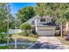 Charming two-story home featuring a well-manicured lawn, mature trees, and a two-car garage at 11386 Churchhill Trl, Seminole, FL 33772