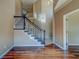 Foyer features hardwood floors, a staircase with dark wood banister and white railings at 11386 Churchhill Trl, Seminole, FL 33772