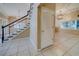 Open foyer with staircase and view into the adjacent living area at 11386 Churchhill Trl, Seminole, FL 33772